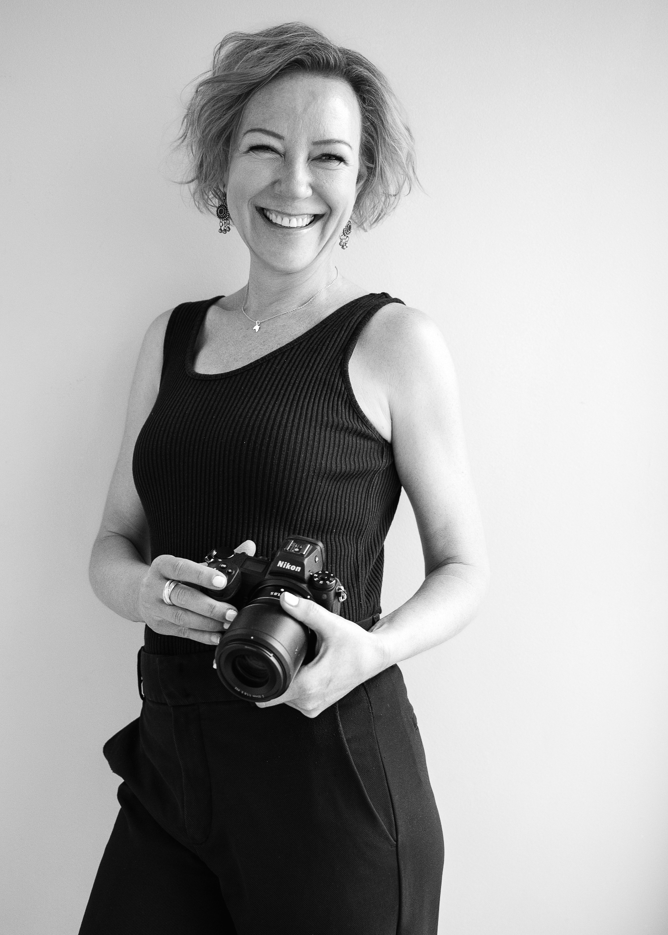 Jules Morgan, portrait photographer, holding her Nikon camera
