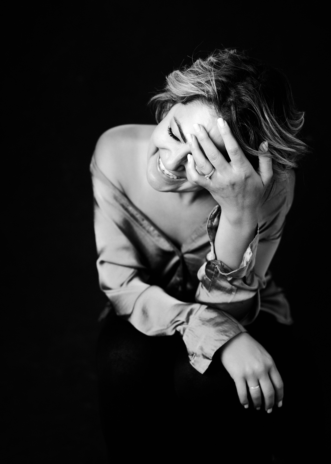 Boss Babe laughing with hand to her forehead in a studio portrait